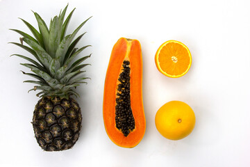 Poster - Juicy Oranges cut isolated and a piece of papaya sliced white background, SET of Healthy fruits, papaya, Oranges, pineapple for smoothie and cooking concepts design