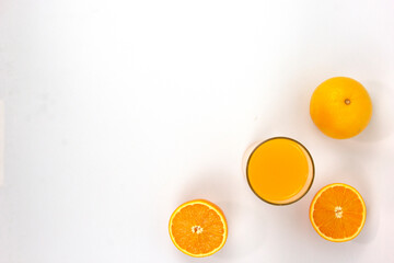 Poster - Two pieces of juicy oranges with glass of orange isolated on white background, top view of BG cornor and space for text writing on center