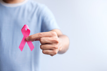 Pink October Breast Cancer Awareness month, man hold pink Ribbon for support people life and illness. National cancer survivors month, Mother and World cancer day concept