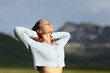 © Antonioguillem - Relaxed female breathing fresh air in the mountain