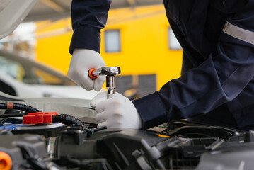 Mechanic man working onsite service on the engine of the car.Car service and maintenance,Repair service.Checks car engine under the hood