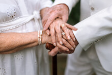 Close-up Of Seniors Hands With Wedding Rings During Their Marriage.