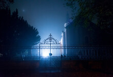 Iron Gate To Old Creepy Graveyard On Creepy Winter Day In Blue Tones
