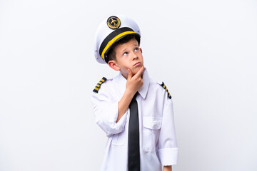 Wall Mural - Little airplane pilot boy isolated on white background having doubts