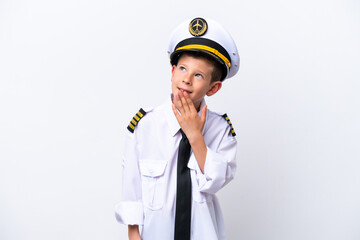 Wall Mural - Little airplane pilot boy isolated on white background looking up while smiling