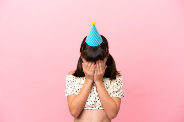 Poster - Little caucasian kid with birthday hat isolated on pink background with tired and sick expression