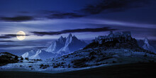 Castle On The Hill At Night. Composite Fantasy Landscape. Grassy Meadow In The Foreground. Rocky Peaks Of The Ridge In The Distant Background In Full Moon Light