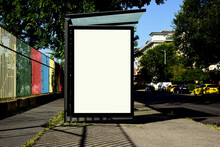 Bus Shelter At A Busstop. Blank Billboard Ad Display. Empty White Lightbox Sign. City Transit Station. Glass And Aluminum Frame Structure. Bench Inside. Urban Street Setting. Outdoor Advertising 
