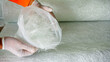 Hand holding composites raw material fiber glass chopper mat stand close up