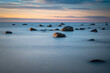Sunrise on the beach with stones on coast