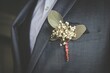 Closeup shot of a boutonniere on the suit of the groom