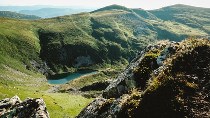 Wall Mural - Carpathian lake Brebeneskul and rocky terrain near it, an attractive place for tourism against background of green mountains