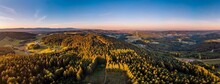 Panoramic Shot Of Dense Mountain Forests And Windmills In Germany
