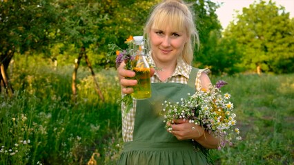 Wall Mural - A woman makes herbal tincture. Selective focus.