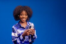 Beautiful Afro-American Lady Listening To Music On The Phone And Looking At The Camera