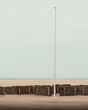Vertical shot of a sandy beach with a wooden fence in Deauville, Normandie, France