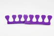 Lilac toe separators for pedicure on a white background