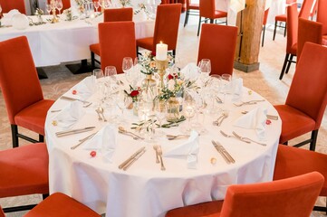 Decorated beautiful wedding table with coral chairs