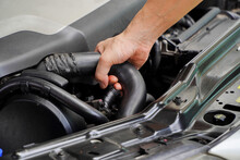 Technician to inspect radiator hose,safety concept,concept of checking the condition of the car before leaving