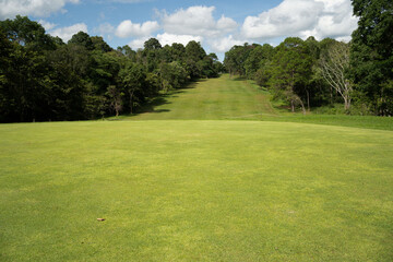 Wall Mural - Background of evening golf course has sunlight shining down at golf course in Thailand.