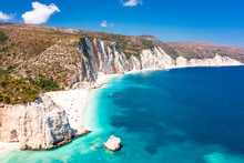 Tourists Sunbathing At Idyllic Fteri Beach Set Among Cliffs And Blue Lagoon, Overhead View, Kefalonia, Ionian Islands, Greek Islands, Greece