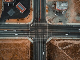 Canvas Print - Drone shot of a crossroad with cars driving from all four directions