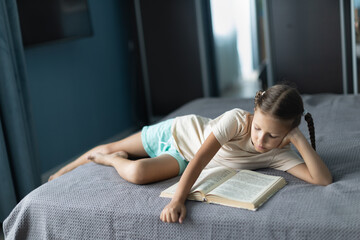 Wall Mural - girl child reads a book in the room