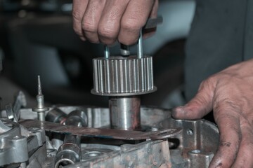 Wall Mural - Close up of auto mechanic's hands repairing car troubleshooting  with tools