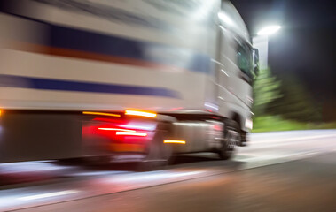 Wall Mural - truck rushes at night along the illuminated road.