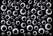 Googly eyes are small plastic craft supplies used to imitate eyeballs isolated on black background.