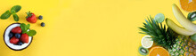 Banner. Tropical Fruits And Berry In Half Coconut On The Yellow Background. Close-up. Copy Space.