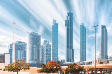 Wall Mural - Construction crane is involved in development of new multi-storey residential building. View of modern skyscrapers in Dubai. Construction development of residential houses among modern glass