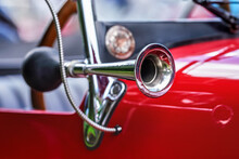 Shiny Steel Horn On Red Vintage Car, Closeup Detail, Only Metal Rim In Focus