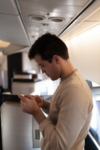Man In First Class Cabin Checkinb Mobile Phone