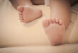 © Lorena - FEET OF A BABY LYING IN BED