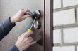 Handyman installing lock in metal door. Checking lock for operability closeup door.