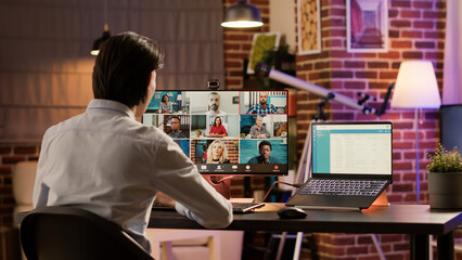 Canvas Print - Entrepreneur chatting on videocall online meeting at home, using remote telecommunications videoconference on computer. Talking to colleagues on virtual teleconference and telework chat.