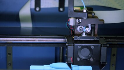Wall Mural - Close-up of moving machine in 3d printer. Media. Creating objects on 3D printer with machine. Process of operation of 3d printer machine during printing