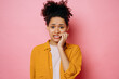 Confused worried african american young woman, in casual wear, looking stressed and nervous with hands on mouth biting nails, looking at camera, is going through, stands on isolated pink background