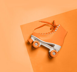 Wall Mural - stylish quad roller skate on orange background, top view