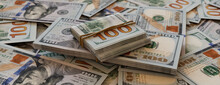 Bundles Of One Hundred Dollar Bills On Scattered Cash. Wealth Concept.