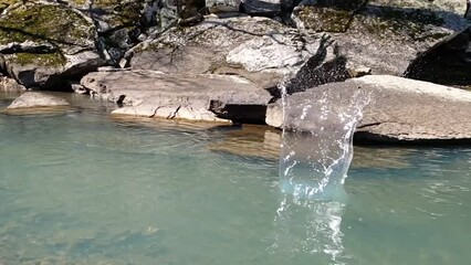 Wall Mural - Rock splashing in the water