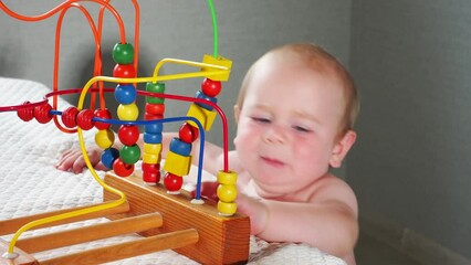 Wall Mural -  child in the home room reaches for a toy lying on the bed