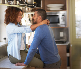 Sticker - If we carry on well never get dinner done. Shot of a young couple sharing a romantic moment in the kitchen.