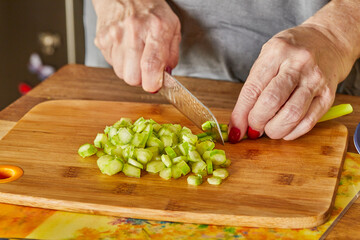 Wall Mural - Chef cuts the asparagus into small pieces to prepare the dish