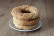 Turkish bagel with sesame and butter in white plant on kitchen table. Known as ‘tereyagli simit’ in Turkish. 