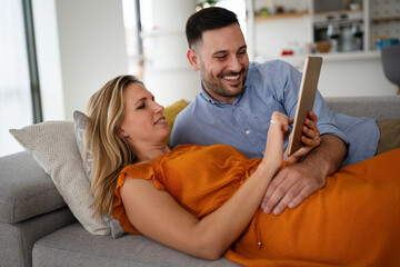 Wall Mural - Portrait of happy couple with tablet,watching something online. People digital device concept.