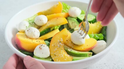 Wall Mural - Summer peach salad with avocado, cucumber and mozzarella. Healthy recipe, vegetarian food concept.