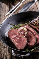 Wall Mural - Grilled beef steak in a pan with herbs