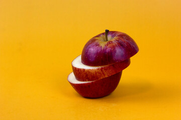 Poster - Sliced apple isolated on yellow background. New isolate style for Fruit concept design